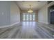 Bright living room featuring hardwood floors, neutral walls, and a modern light fixture at 19334 Autumn Woods Ave, Tampa, FL 33647