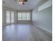 Inviting living room with neutral walls, large windows, and French doors that fill the space with natural light at 19334 Autumn Woods Ave, Tampa, FL 33647