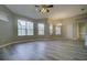 Spacious living room features lots of natural light, wood-style floors, and access to kitchen and back patio at 19334 Autumn Woods Ave, Tampa, FL 33647