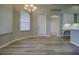 Spacious living room features lots of natural light, wood-style floors, and access to kitchen and back patio at 19334 Autumn Woods Ave, Tampa, FL 33647