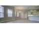 Spacious living room features lots of natural light, wood-style floors, and access to kitchen and back patio at 19334 Autumn Woods Ave, Tampa, FL 33647