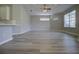 Bright living room featuring hardwood floors, neutral walls, and a modern light fixture at 19334 Autumn Woods Ave, Tampa, FL 33647