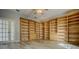 Large office with ample built-in shelving and storage, complemented by stylish flooring and bright lighting at 19334 Autumn Woods Ave, Tampa, FL 33647