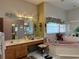 Large bathroom with double sinks, corner tub, and separate shower at 33255 State Road 70 E, Myakka City, FL 34251