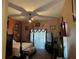 Primary bedroom with a king-size bed, large windows and ceiling fan at 33255 State Road 70 E, Myakka City, FL 34251