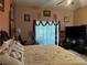 Spacious bedroom with a large bed, TV, and plenty of natural light at 33255 State Road 70 E, Myakka City, FL 34251