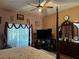 Bright bedroom featuring a post bed, large windows and a ceiling fan at 33255 State Road 70 E, Myakka City, FL 34251