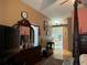 Primary bedroom with a four-poster bed and view of the bathroom at 33255 State Road 70 E, Myakka City, FL 34251