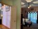 Primary bedroom with a four-poster bed and ceiling fan at 33255 State Road 70 E, Myakka City, FL 34251
