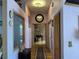 Long hallway with light walls and wood flooring at 33255 State Road 70 E, Myakka City, FL 34251