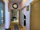 Bright hallway with hardwood floors and access to other rooms at 33255 State Road 70 E, Myakka City, FL 34251