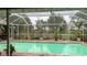 Enclosed pool with lush tropical plants offering a relaxing atmosphere at 33255 State Road 70 E, Myakka City, FL 34251