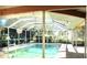 Enclosed pool area with a refreshing pool and surrounding plants at 33255 State Road 70 E, Myakka City, FL 34251