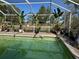 Inviting screened pool area with lush tropical plants at 33255 State Road 70 E, Myakka City, FL 34251
