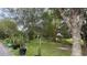 Landscaped yard with mature trees and lighting at 33255 State Road 70 E, Myakka City, FL 34251
