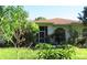 House exterior with lush landscaping and brown roof at 33255 State Road 70 E, Myakka City, FL 34251