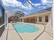 Relaxing screened-in pool area with patio furniture, ideal for outdoor entertaining at 19334 Autumn Woods Ave, Tampa, FL 33647