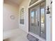 Inviting front entryway with a large gray door and arched windows at 19334 Autumn Woods Ave, Tampa, FL 33647