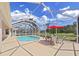 Screened pool area with patio furniture at 19334 Autumn Woods Ave, Tampa, FL 33647