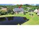 Aerial view of a house with a pool and a pond in the backyard at 19334 Autumn Woods Ave, Tampa, FL 33647