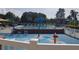 Community pool with spray park and lounge chairs at 19334 Autumn Woods Ave, Tampa, FL 33647