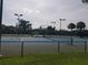 Well-maintained tennis courts with covered seating area at 19334 Autumn Woods Ave, Tampa, FL 33647