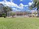 Relaxing pool area with screened enclosure and lush landscaping at 19334 Autumn Woods Ave, Tampa, FL 33647