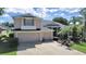 Two-story house with a two-car garage and landscaped yard at 19334 Autumn Woods Ave, Tampa, FL 33647