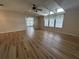 Spacious living room with hardwood floors, multiple windows, and ceiling fan at 6048 Ridgeway Dr, Zephyrhills, FL 33542