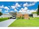 Mobile home with carport, workshop, and manicured lawn at 6048 Ridgeway Dr, Zephyrhills, FL 33542