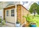 Wooden workshop with double doors, steps and potted plants at 6048 Ridgeway Dr, Zephyrhills, FL 33542