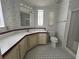 Bathroom with corner vanity, checkered floor, and shower at 6048 Ridgeway Dr, Zephyrhills, FL 33542