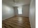 Simple bedroom with light walls and wood-look flooring at 6048 Ridgeway Dr, Zephyrhills, FL 33542