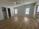 Large bedroom with wood-look floors and a double door closet at 6048 Ridgeway Dr, Zephyrhills, FL 33542