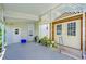 Covered patio area with storage and potted plants at 6048 Ridgeway Dr, Zephyrhills, FL 33542