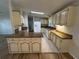 Eat-in kitchen with a peninsula, light-colored cabinets, and tile floors at 6048 Ridgeway Dr, Zephyrhills, FL 33542