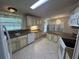 Spacious kitchen with light wood cabinets, granite countertops, and tile floors at 6048 Ridgeway Dr, Zephyrhills, FL 33542