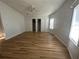 Bright bedroom featuring wood-look floors and double door closet at 6048 Ridgeway Dr, Zephyrhills, FL 33542