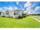 Mobile home with side yard and beautiful landscaping at 6048 Ridgeway Dr, Zephyrhills, FL 33542