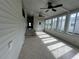 Bright sunroom with tiled floor and ceiling fan at 6048 Ridgeway Dr, Zephyrhills, FL 33542