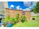 Landscaped yard with shed and colorful plants at 6048 Ridgeway Dr, Zephyrhills, FL 33542