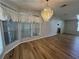 Dining room with hardwood floors and a crystal chandelier at 6048 Ridgeway Dr, Zephyrhills, FL 33542