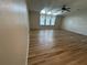 Spacious living room with hardwood floors, multiple windows, and ceiling fan at 6048 Ridgeway Dr, Zephyrhills, FL 33542
