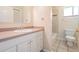 Bathroom with white vanity, neutral tile, and a combined tub and shower at 6536 Northlake Dr, Zephyrhills, FL 33542