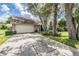 Charming home exterior with a two-car garage and well-manicured landscaping at 6536 Northlake Dr, Zephyrhills, FL 33542