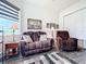 Cozy sitting area with two reclining chairs and a window seat at 15503 Corona Del Mar Dr, Wimauma, FL 33598