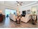 Spacious living room with two sofas, a coffee table, and a large TV at 15503 Corona Del Mar Dr, Wimauma, FL 33598