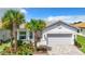 Single-Gathering house with a two-car garage and manicured lawn at 15503 Corona Del Mar Dr, Wimauma, FL 33598