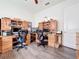Home office featuring two desks, built-in cabinets, and ceiling fan at 15503 Corona Del Mar Dr, Wimauma, FL 33598