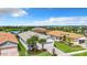 Single-Gathering house with a two-car garage and landscaped yard, aerial view at 15503 Corona Del Mar Dr, Wimauma, FL 33598